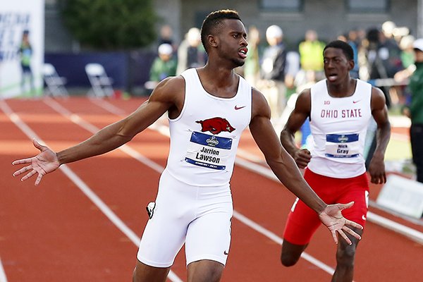 Arkansas' Jarrion Lawson, left, wins the men's 200-meter dash at the NCAA outdoor track and field championships in Eugene, Ore., Friday, June 10, 2016. (AP Photo/Ryan Kang)
