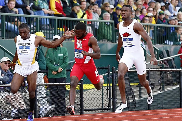 Arkansas' Jarrion Lawson, right, finishes first in the men's 100 meter dash in front of Missouri's Markesh Woodson, left, and Houston's Cameron Burrell, middle, at the NCAA outdoor track and field championships in Eugene, Ore., Friday, June 10, 2016. (AP Photo/Ryan Kang)