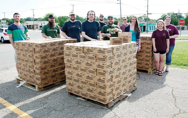 Arkansas Tech University students and faculty unloaded several pallets of trial-size body wash donated by Unilever for the Because We Can organization’s hygiene drive. The body wash was given to the Russellville School District, as well as shelters and other community organizations. In the front row, from left, are Mason Sims, Derec Carson, James Stobaugh, Jason Warnick, Sean Huss, Chelsea Johnson, Sydney Skaggs and Danielle Hurst; and back row, Jericho McElroy, left, and Logan Felder.