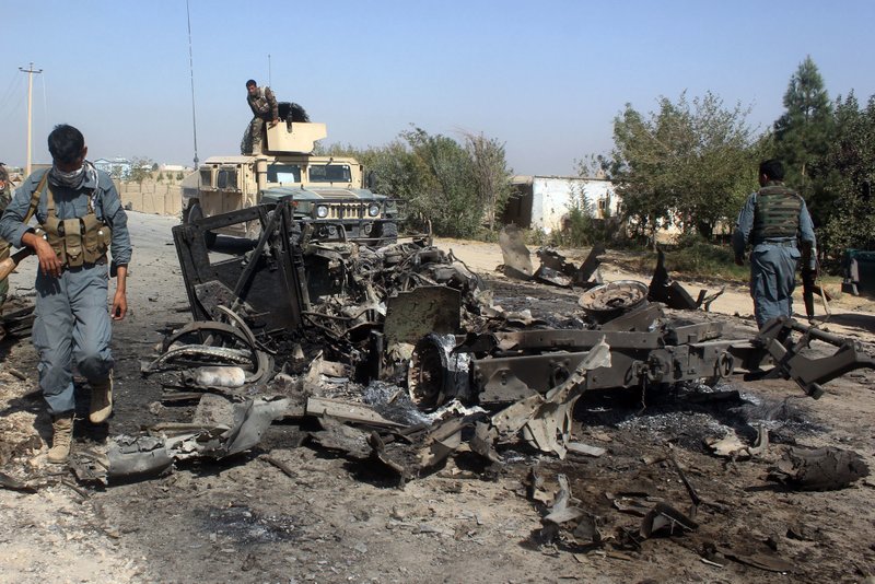 Afghan security forces inspect the site of a U.S. airstrike Oct. 2 in Kunduz city, north of Kabul, Afghanistan. 