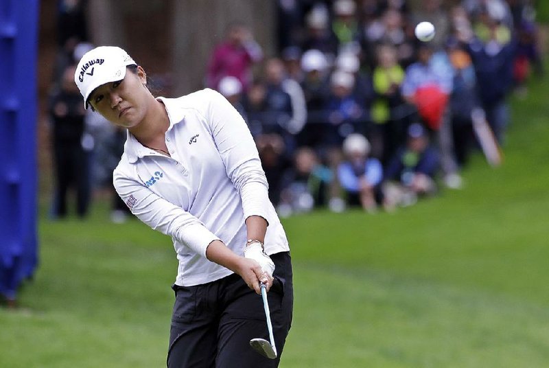 Lydia Ko chips onto the 17th green in the third round of the Women’s PGA Championship on Saturday in Sammamish, Wash. Ko will take a one-shot lead into today’s final round.