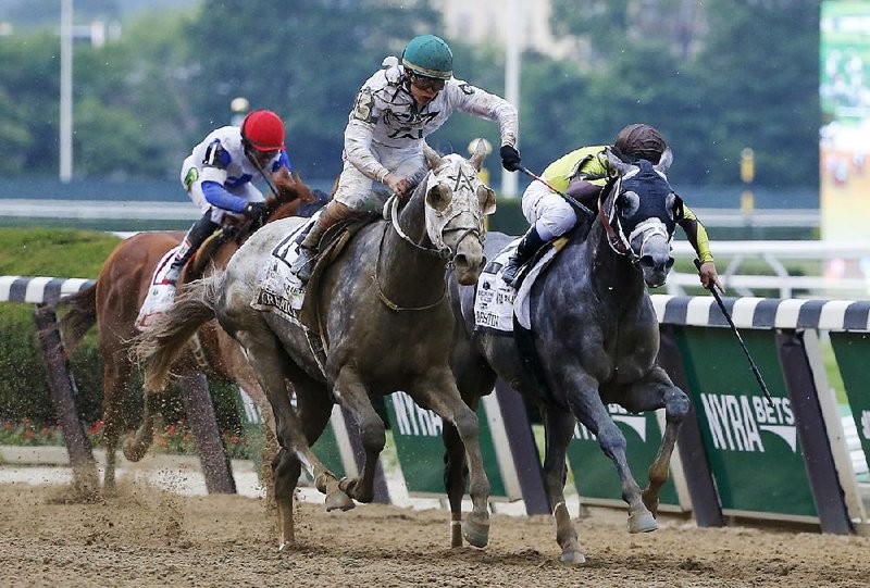 Jockey Irad Ortiz Jr. rides Creator (left) across the fi nish line just ahead of jockey Javier Castellano and Destin to win the 148th running of the Belmont Stakes in a photo fi nish Saturday at Belmont Park in Elmont, N.Y.