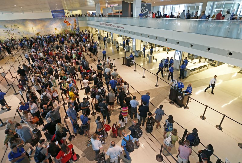 The Transportation Security Administration checkpoint reopens following an officer involved shooting, as travels wait in line at Dallas Love Field airport on Friday, June 10, 2016, in Dallas. 