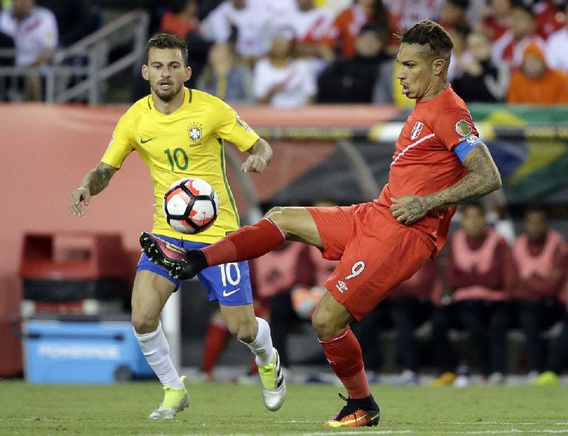 Peru’s Jose Paolo Guerrero (9) juggles the ball past Brazil’s Lucas Lima (10) during the first half of Peru’s 1-0 victory over Brazil in Sunday’s Copa America Tournament.