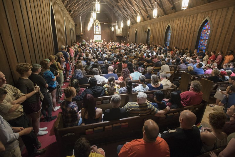 A standing room only crowd listens to the Rev. Lowell Grisham Sunday at St. Paul’s Episcopal Church in Fayetteville during a vigil for the victims of the Orlando, Fla., shooting.