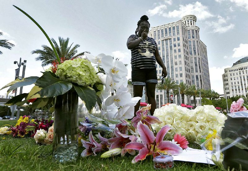 Krystle Martin weeps Monday in Orlando, Fla., at a makeshift memorial for victims of the mass shooting early Sunday at the Pulse Orlando nightclub.