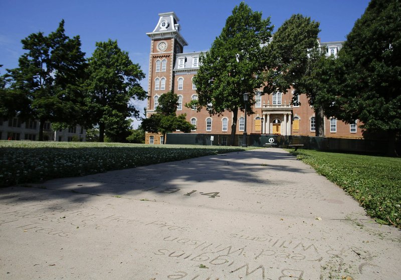 Names from the University of Arkansas graduating class of 1915 on the Senior Walk are shown on the east side of Old Main on the campus in Fayetteville.