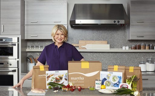 In this photo provided by Marley Spoon, Inc., Martha Stewart poses with ingredients from a meal kit. 