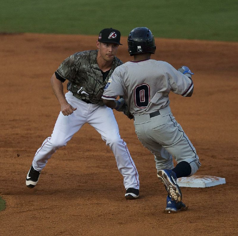 Arkansas second baseman Alex Yarbrough waits to tag out Northwest Arkansas’ Terrance Gore at second base during the second inning of the Travelers’ 6-1 victory over the Naturals on Tuesday at Dickey-Stephens Park in North Little Rock. Gore finished 2 for 2, while Yarbrough went 3 for 4 with 2 runs scored and 1 RBI.