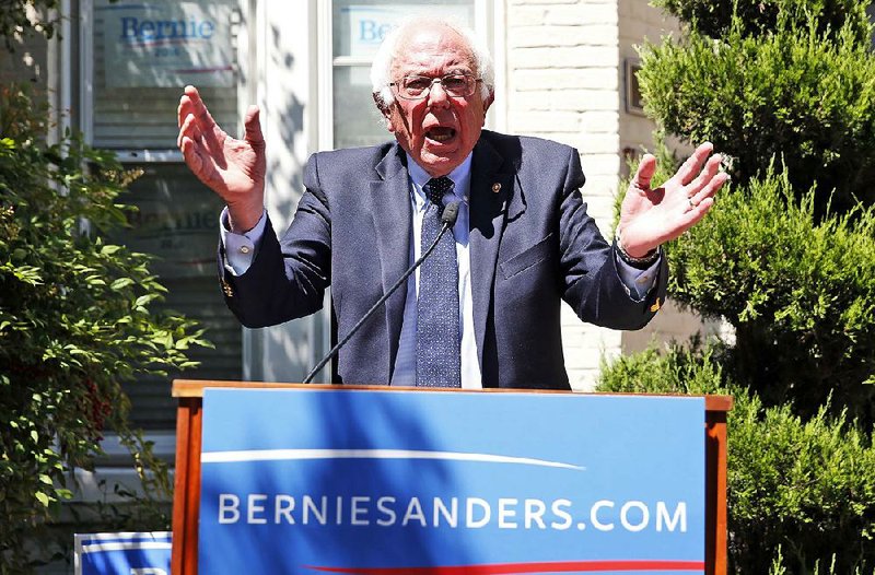 Bernie Sanders holds a news conference Tuesday outside his campaign headquarters in Washington. He vowed to continue to “fight as hard as we can” to transform the Democratic Party.
