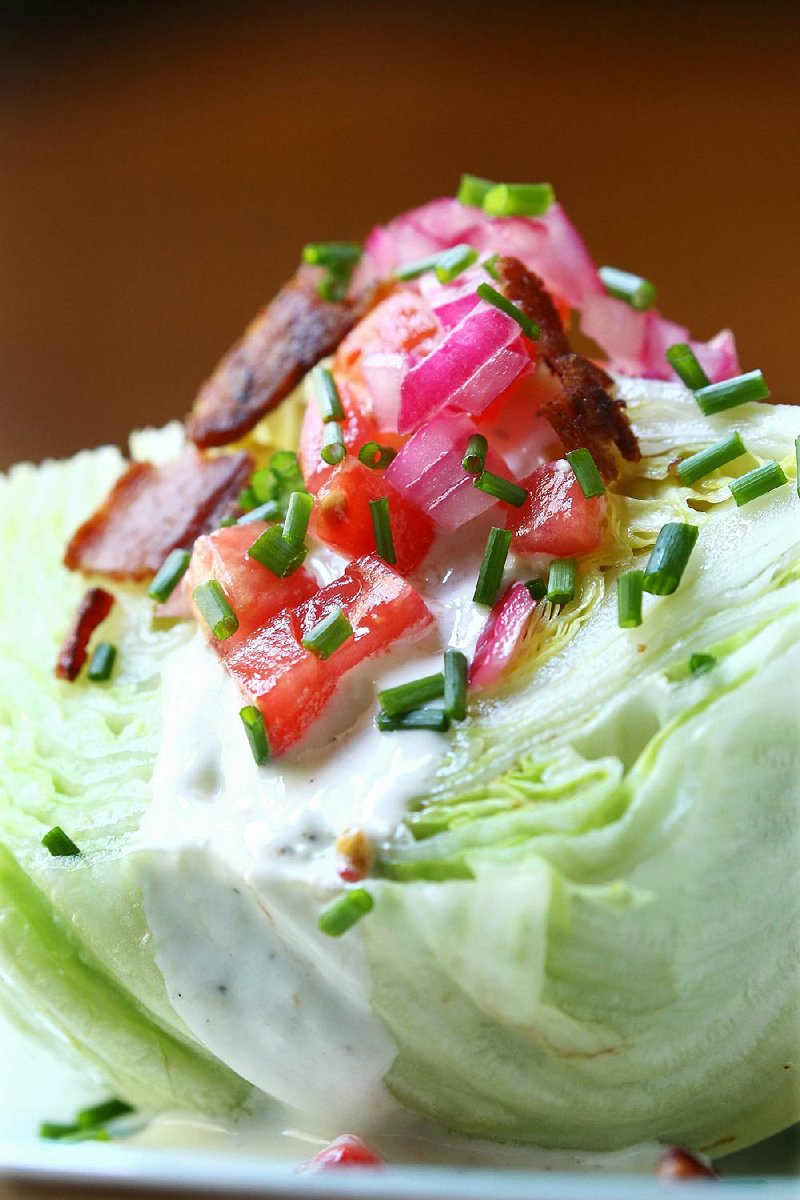 This Loaded Wedge salad features quick-pickled onions, tomatoes, bacon, chives and a homemade dressing. 