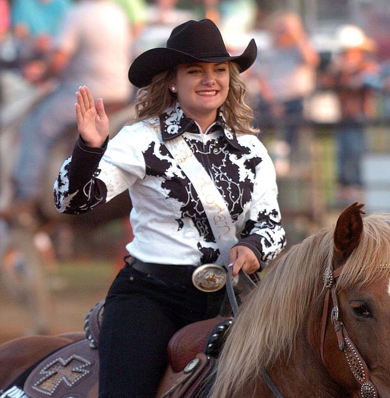 MIKE CAPSHAW ENTERPRISE-LEADER Loran Lopez waves to the crowd while riding in the grand entry. The 20-year-old from Booneville was crowned queen during the 63rd Annual Lincoln Riding Club Rodeo on Saturday, June 11.