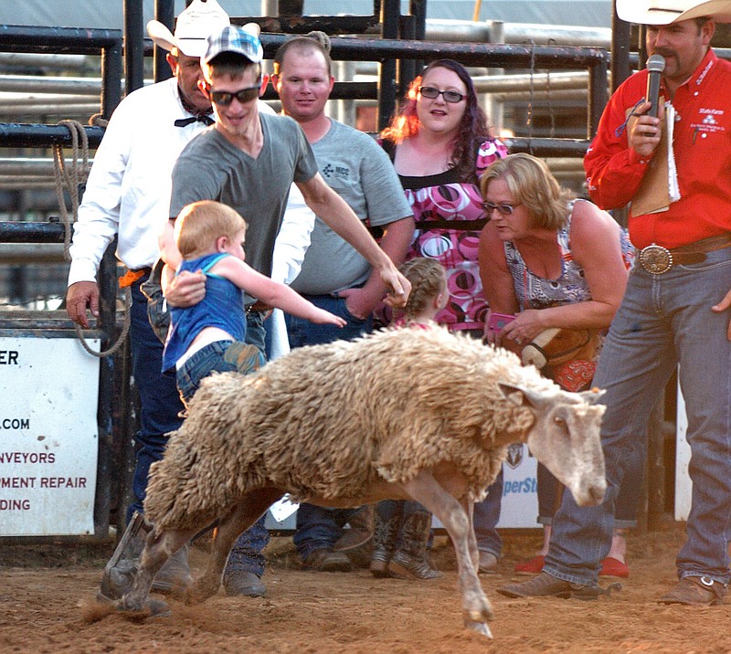 MIKE CAPSHAW ENTERPRISE-LEADER Two-year-old Daniel Long was the youngest participant in the Mutton Bustin&#8217; competition and jumped into his dad&#8217;s arms about a second into the ride.