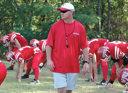 The Sentinel-Record/Mara Kuhn COMING HOME: Mountain Pine football coach Jody Frazier warms up his team prior to the 2007 Jessieville Jamboree scrimmages. A Mountain Pine graduate who coached the Red Devils for 17 years, Frazier died Monday at age 50.