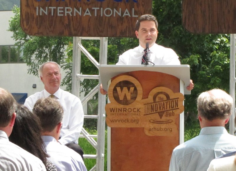 Innovation Hub Executive Director Warwick Sabin, with Gov. Asa Hutchinson to his right, speaks Wednesday, June 15, 2016, during a news conference at Winrock International in Little Rock.