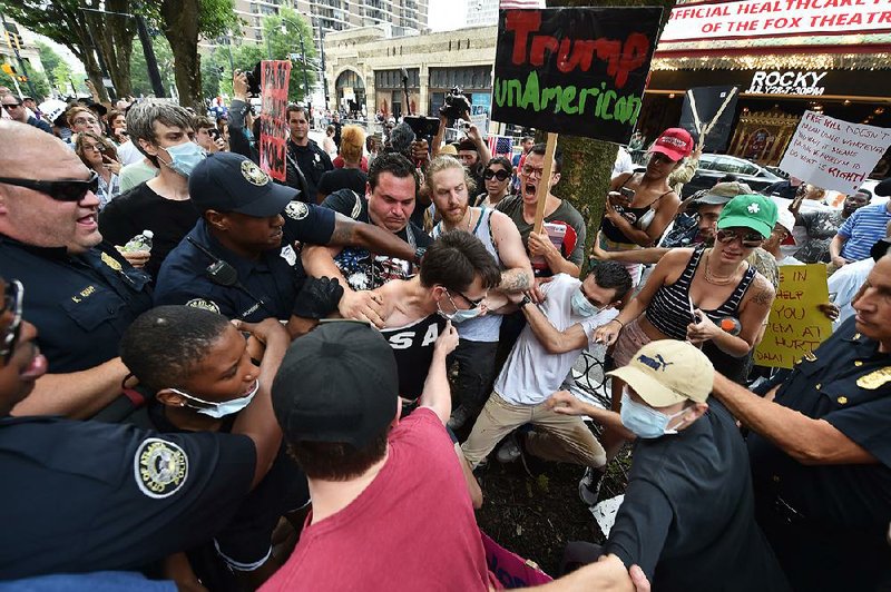 Atlanta police move in to arrest protesters Wednesday outside a campaign rally for Donald Trump at the Fox Theater in Atlanta.