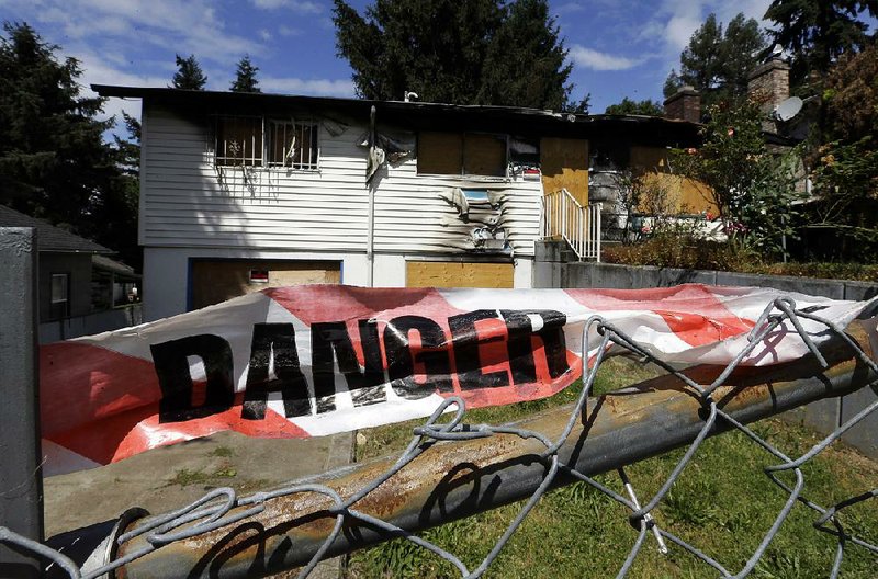 A fire-damaged and boarded-up house sits empty Tuesday in Portland, Ore., where city officials plan to take possession of abandoned houses to improve neighborhoods and ease a housing shortage. 
