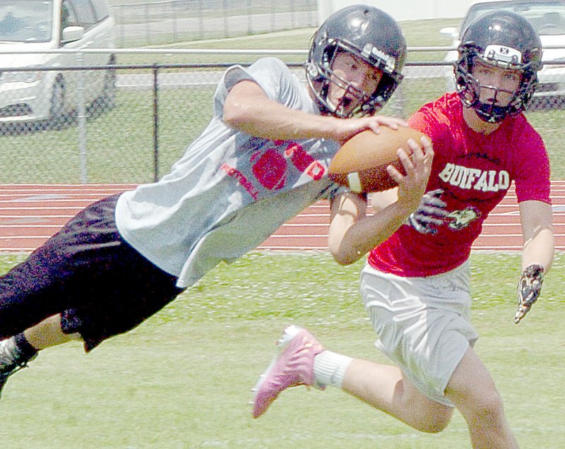 McDonald County wide receiver Cole DelosSantos dives to make a catch during the Mustangs&#8217; 7-on-7 scrimmage against Buffalo High School on Saturday at MCHS.