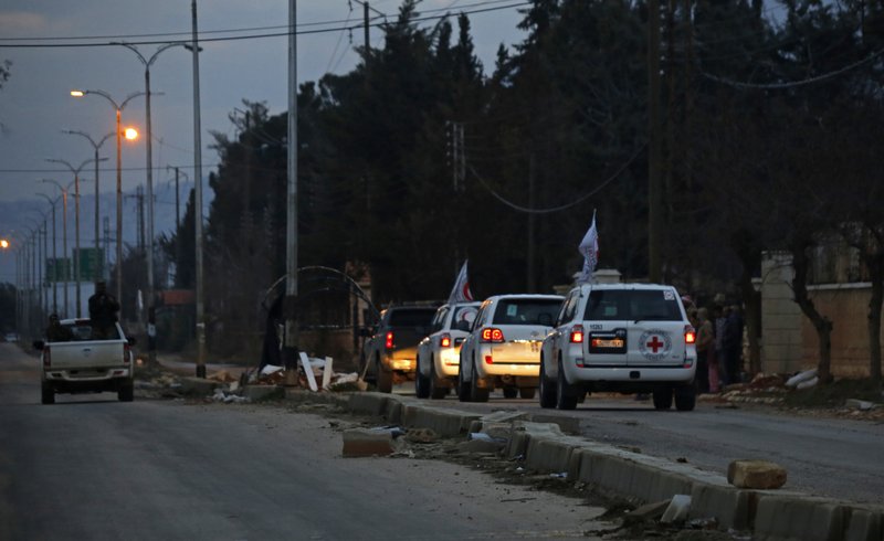  In this Monday, Jan. 11, 2016 file photo, a convoy of cars loaded with food and other supplies heads toward the besieged town of Madaya, northwest of Damascus, Syria. 