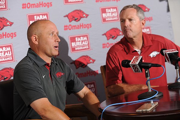 Newly hired pitching coach Wes Johnson (left) speaks alongside Arkansas coach Dave Van Horn Thursday, June 16, 2016, during a press conference to announce his hire at Baum Stadium in Fayetteville. A native of Sherwood, Johnson comes to Arkansas after a year at Mississippi State.