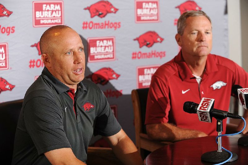 NWA Democrat-Gazette/ANDY SHUPE
Newly hired pitching coach Wes Johnson (left) speaks alongside Arkansas coach Dave Van Horn Thursday, June 16, 2016, during a press conference to announce his hire at Baum Stadium in Fayetteville. A native of Sherwood, Johnson comes to Arkansas after a year at Mississippi State.