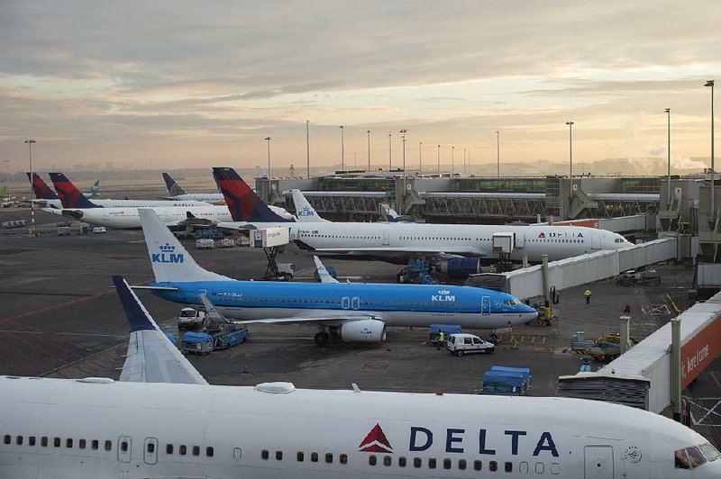 Passenger aircraft operated by KLM, the Dutch arm of Air France-KLM Group, and passenger jets operated by Delta Air Lines sit at gates at Schiphol Airport in Amsterdam in this file photo.