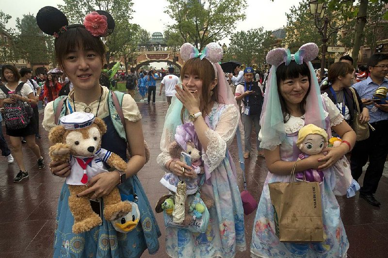 Visitors dress in Disney-themed costumes Thursday for the opening of the Disney park in Shanghai.