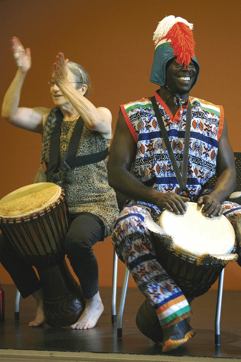 Members of Afrique Aya, including master drummer Angelo Kouakou Yao, right, perform at the Fayetteville Public Library. The group will bring the music and culture of West Africa to the Lincoln and Prairie Grove libraries June 29 as part of the Washington County Library System summer programming.