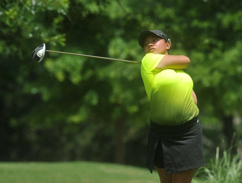 Harmie Constantino from Taguig, Philippines, watches her shot Thursday off the 18th tee during the American Junior Golf Association Junior All-Star golf tournament at the Lost Springs Golf and Athletic Club in Rogers. Constantino finished first, shooting a -13 for the tournament.