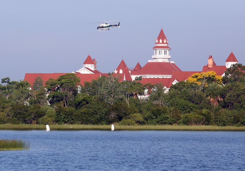 An Orange County Sheriffs helicopter searches for a young boy early Wednesday, June 15, 2016, after the boy was dragged into the water Tuesday night by an alligator near Disney's upscale Grand Floridian Resort & Spa in Lake Buena Vista, Fla. 