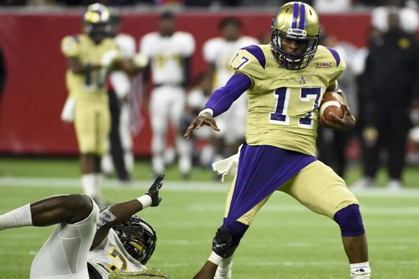 Alcorn State quarterback Lenorris Footman (17) escapes the tackle of Grambling State defensive back Jameel Jackson (33) in the third quarter of the Southwestern Athletic Conference championship college football game, Saturday, Dec. 5, 2015, in Houston. Alcorn State won the game 49-21. (AP Photo/Eric Christian Smith)
