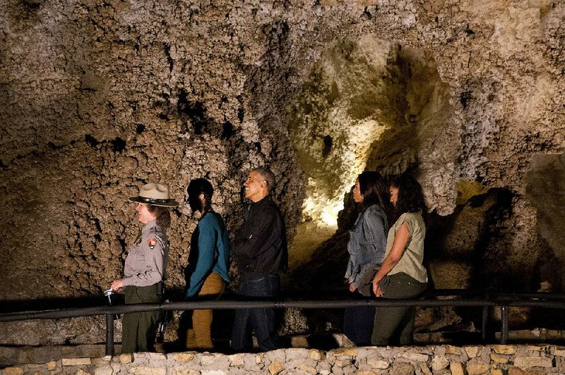 A National Park Service officer leads President Barack Obama and family on a tour of Carlsbad Caverns in Carlsbad, N.M., on Friday.