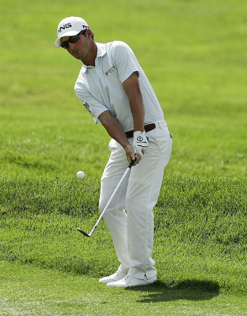 Andrew Landry hits a chip on the first hole during the final round of the U.S. Open golf championship at Oakmont Country Club on Sunday, June 19, 2016, in Oakmont, Pa. 