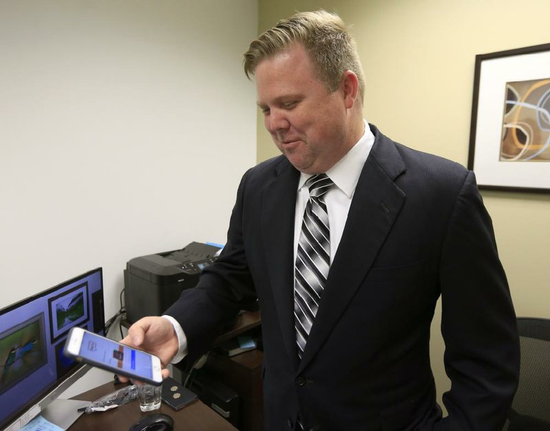 Attorney Rick Davis, who uses text and chat to communicate with clients, accesses his chat room earlier this month while in his office in Leawood, Kan.