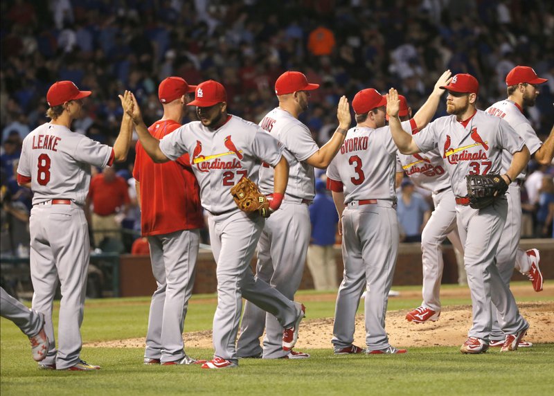 The St. Louis Cardinals celebrate the team's 3-2 win over the Chicago Cubs in a baseball game Monday, June 20, 2016, in Chicago. 