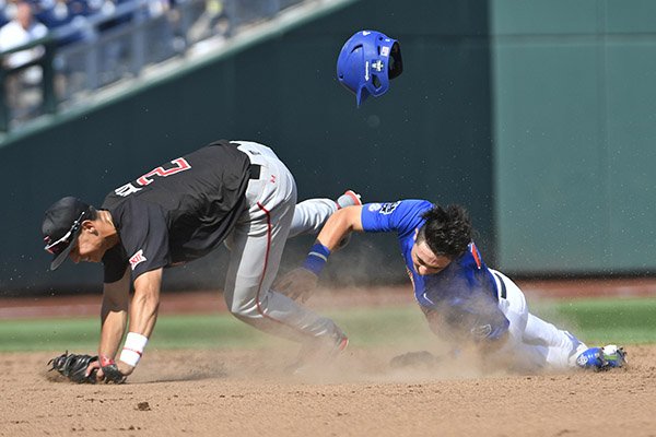 Florida's Jonathan India, right, collides with Texas Tech's Orlando Garcia (2) as he slides into second base in the fifth inning of an NCAA men's College World Series baseball game, Tuesday, June 21, 2016, in Omaha, Neb. India was safe at second base. (AP Photo/Ted Kirk)