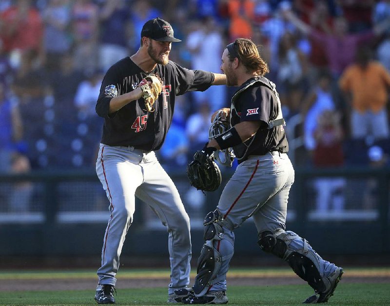 Texas Tech relief pitcher Hayden Howard (left) and catcher Tyler Floyd celebrate after the Red Raiders’ 3-2 victory over Florida at the College World Series in Omaha, Neb., on Tuesday.