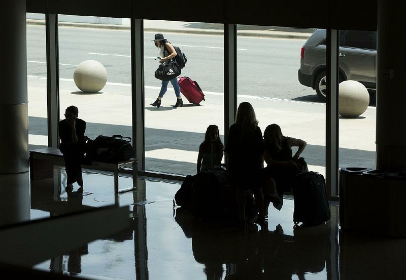 Travelers arrive and depart Tuesday at Bill and Hillary Clinton National Airport/Adams Field. Airport officials say the turnaround in passenger traffic is the result of years of work. 