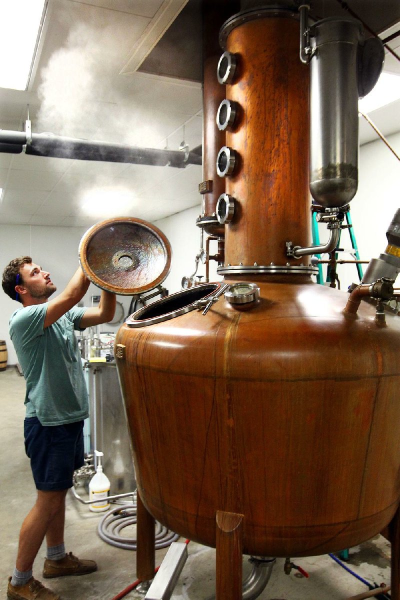 Luke Klifman works Tuesday at a whiskey still at Rock Town Distillery. The distillery is hoping to move to a “big, flat lot” on Capitol Avenue, owner Phil Brandon said. 