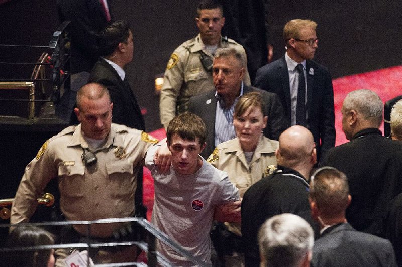 Police detain Michael Steven Sandford on Saturday during a speech by Donald Trump in Las Vegas. 