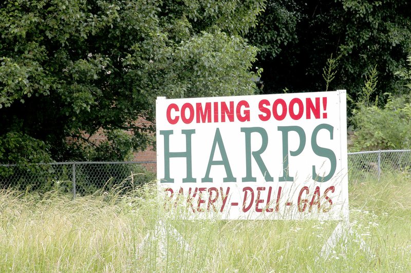 LYNN KUTTER ENTERPRISE-LEADER This Harps sign on vacant land along Pridemore Drive in Lincoln announces the location of a new grocery store.