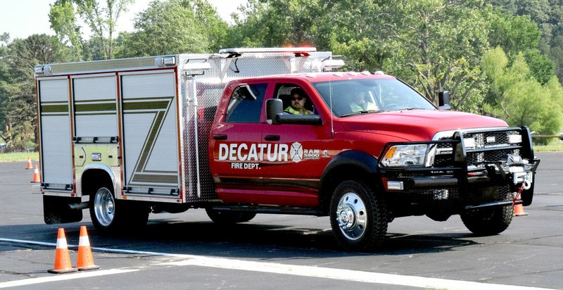 Photo by Mike Eckels Decatur Fire Department&#8217;s new rescue unit is navigated through an obstacle course as part of the department&#8217;s driver-training course at Crystal Lake Airport runway in Decatur on June 11.