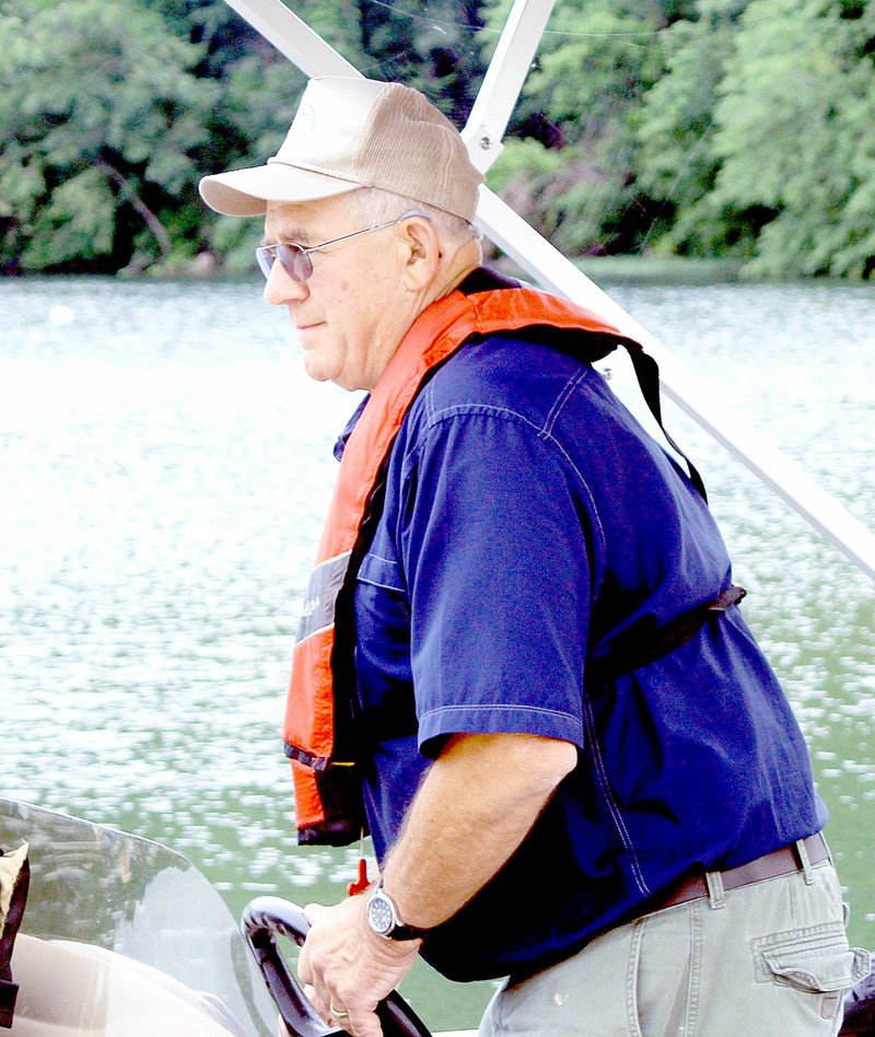 Photo submitted Bella Vista Fly-Tyers president Ed Fischer captains a pontoon boat at the Kids Fishing Day event.