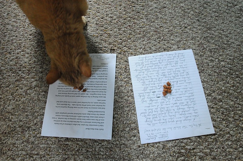 NWA Democrat-Gazette/FLIP PUTTHOFF Boat Dock, chief fish story judge, goes to the story by Warren Wilkey of Garfield to get his treat. That makes Wilkey winner of the 2016 Northwest Arkansas Democrat-Gazette fish story contest.