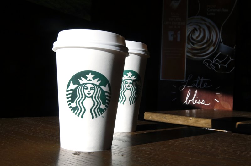 FILE - In this this Friday, Jan. 17, 2014, file photo, Starbucks cups are shown mugs in a cafe in North Andover, Mass. A federal judge in San Francisco ruled on Friday, June 17, 2016, that a lawsuit claiming the Seattle-based coffee chain under fills its lattes can move forward. (AP Photo/Elise Amendola, File)