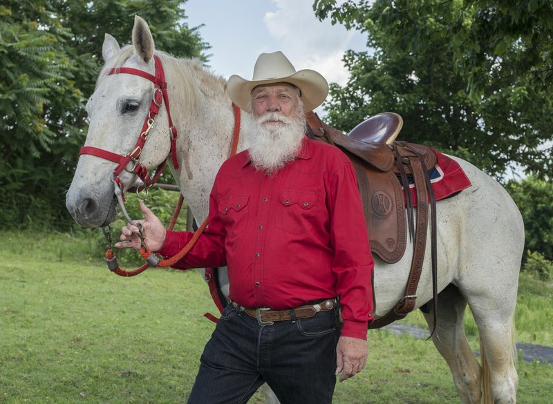 Lonnie Horn with his Missouri Foxtrot, Blue, stops Monday outside his home in Springdale. Horn has ridden in the Rodeo of the Ozarks parade and Rodeo of the Ozarks grand entry for 55 years.