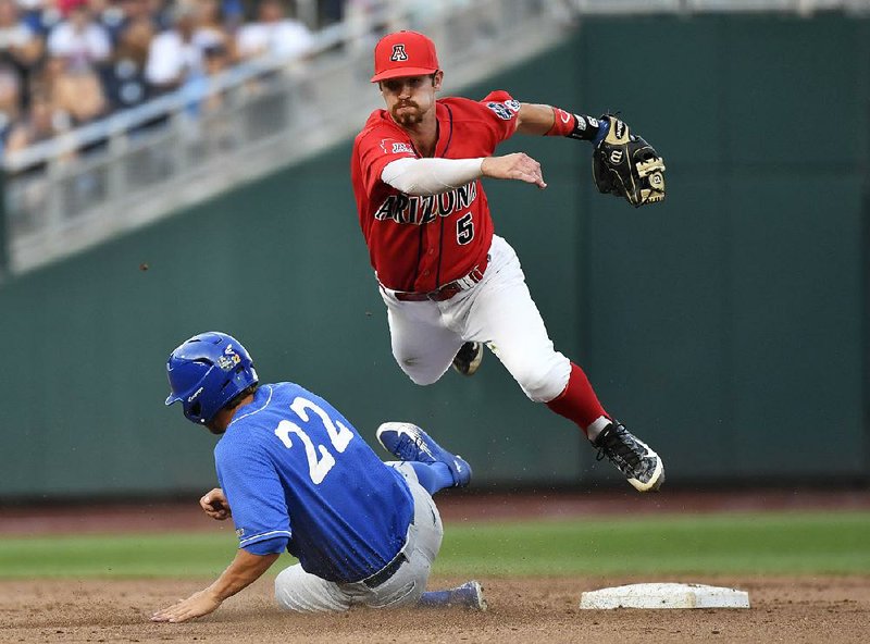 Arizona’s Louis Boyd turns a double play over UC Santa Barbara’s Kyle Plantier during Wednesday’s game at the College World Series in Omaha, Neb. 