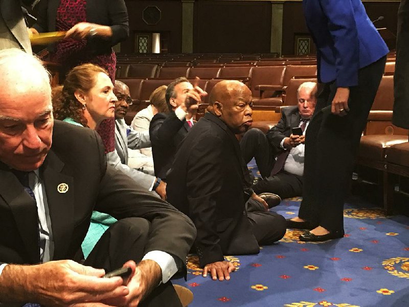 Rep. John Lewis (center) of Georgia leads fellow Democrats in a sit-in Wednesday on the floor of the House. At left is Rep. Joe Courtney of Connecticut.