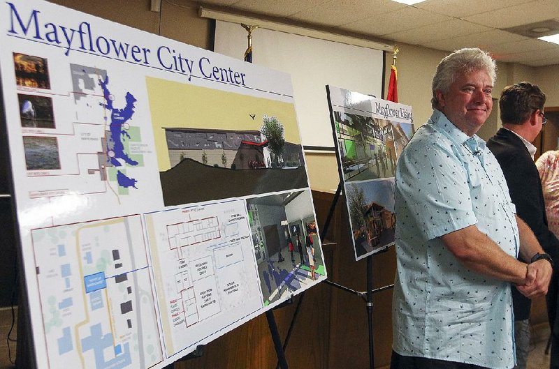 Mayor Randy Holland of Mayflower displays plans Wednesday for a future City Hall and nature pavilion funded in part with Exxon Mobil’s $500,000 payment. 