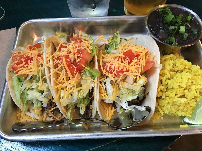 Shredded Chuck Beef Tacos come with black beans and yellow rice at Taco Beer Burrito. 